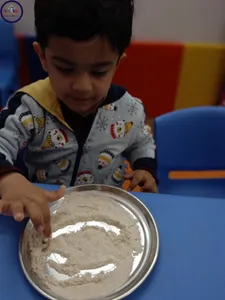 Pre nursery class activity:- alphabet tracing on wheat flour.